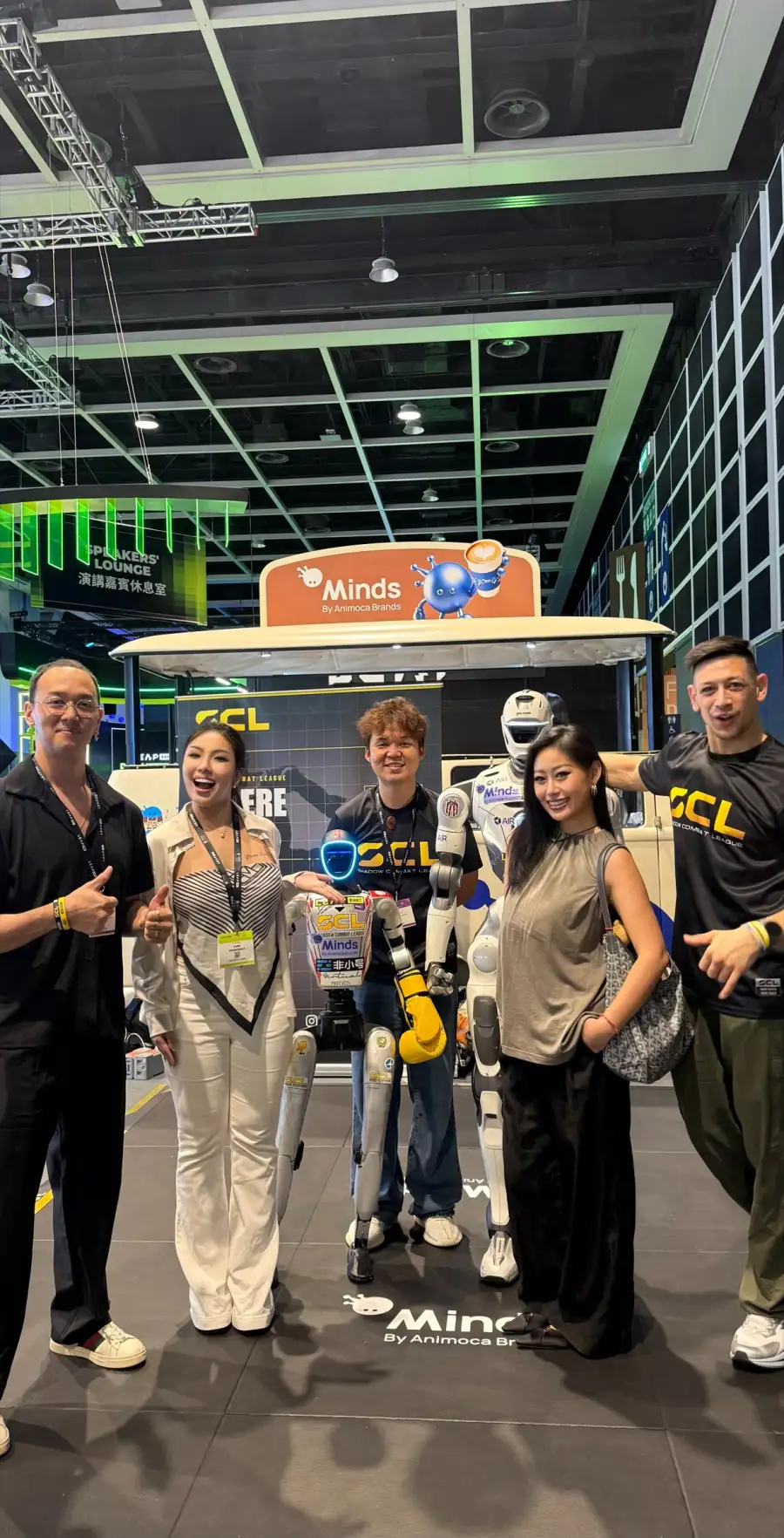 Flawless Effect with partners at a technology exhibition stand featuring a humanoid robot