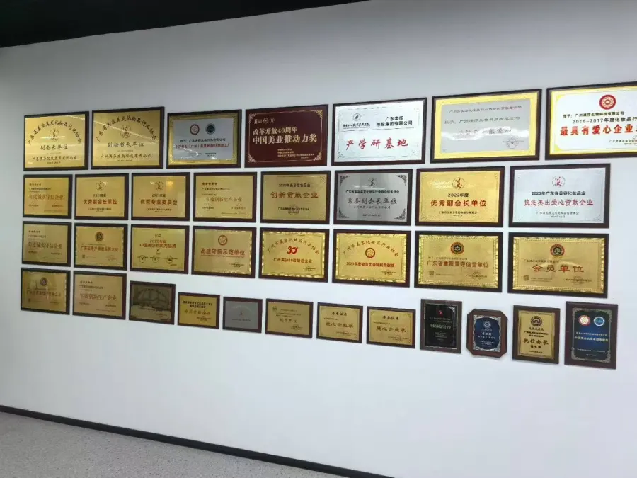 Wall of qualification plaques photographed during a factory visit in China