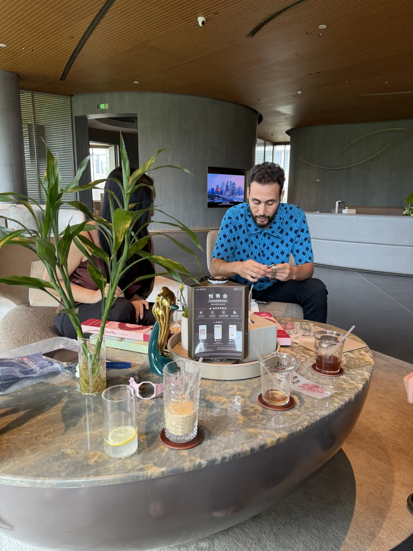 A visiting buyer seated at a table reviewing product samples and papers in Flawless Effect’s Guangzhou meeting space