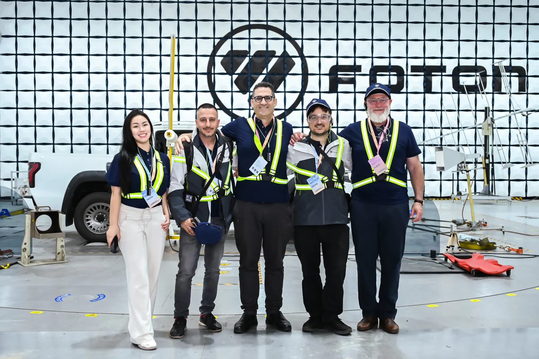 The Flawless Effect team with international partners inside a vehicle test chamber at an automotive factory